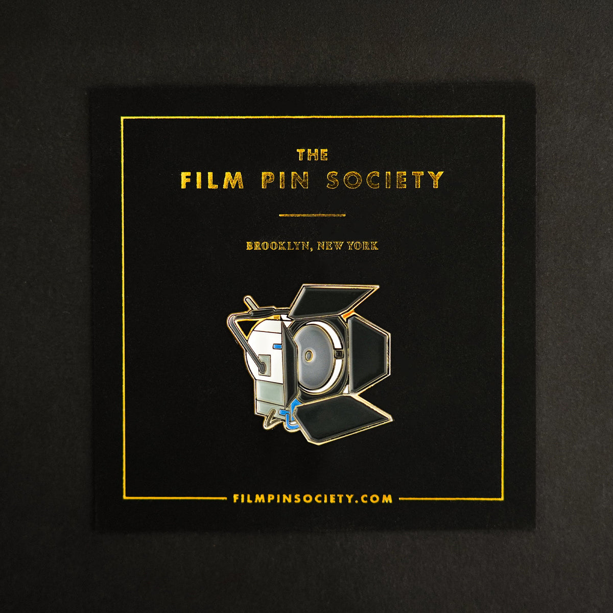 4K HMI Light Enamel Pin on backing card