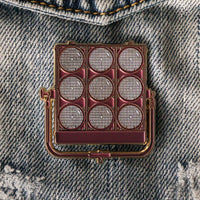 9 Light Enamel Pin on a jacket