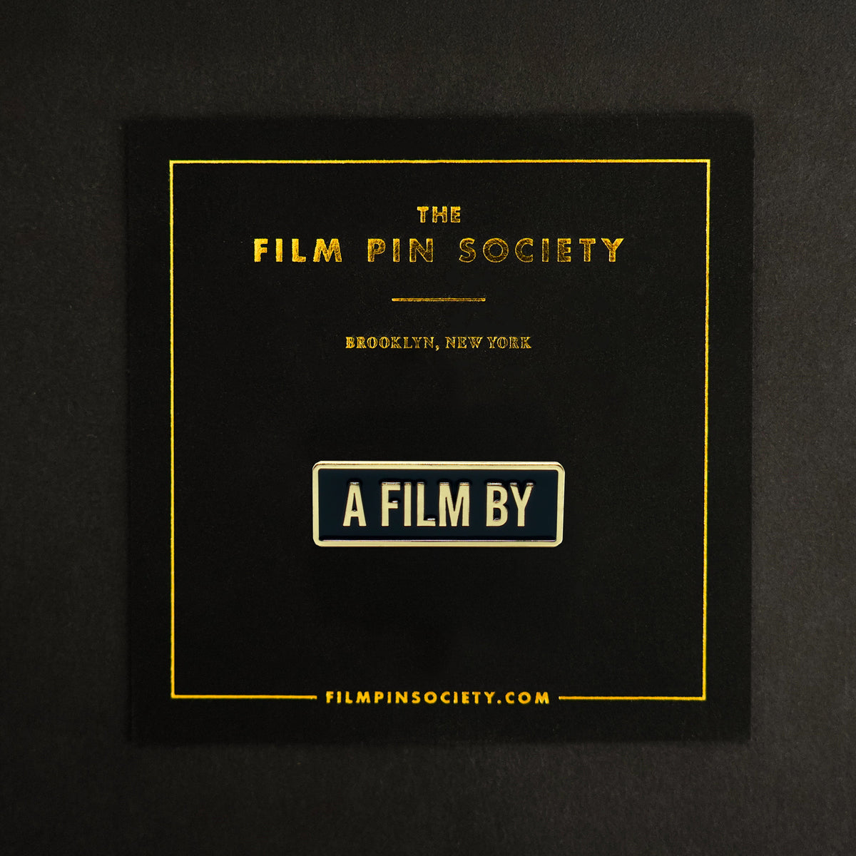 A Film By Credit Enamel Pin on backing card