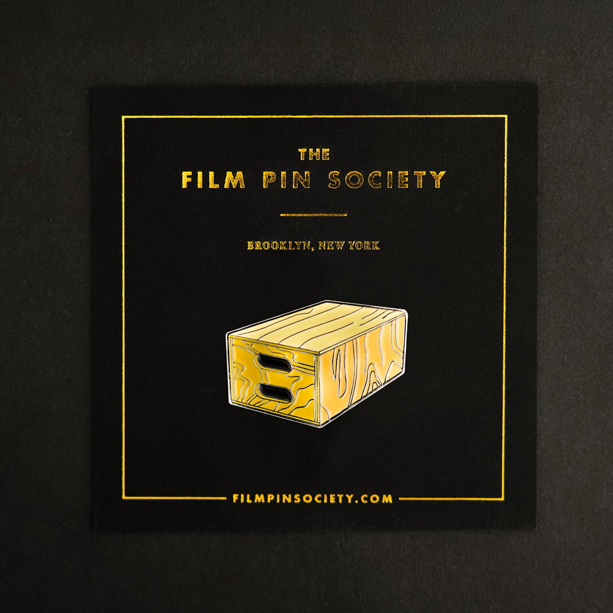 Apple Box Enamel Pin on backing card