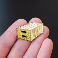 Apple Box Enamel Pin in hand