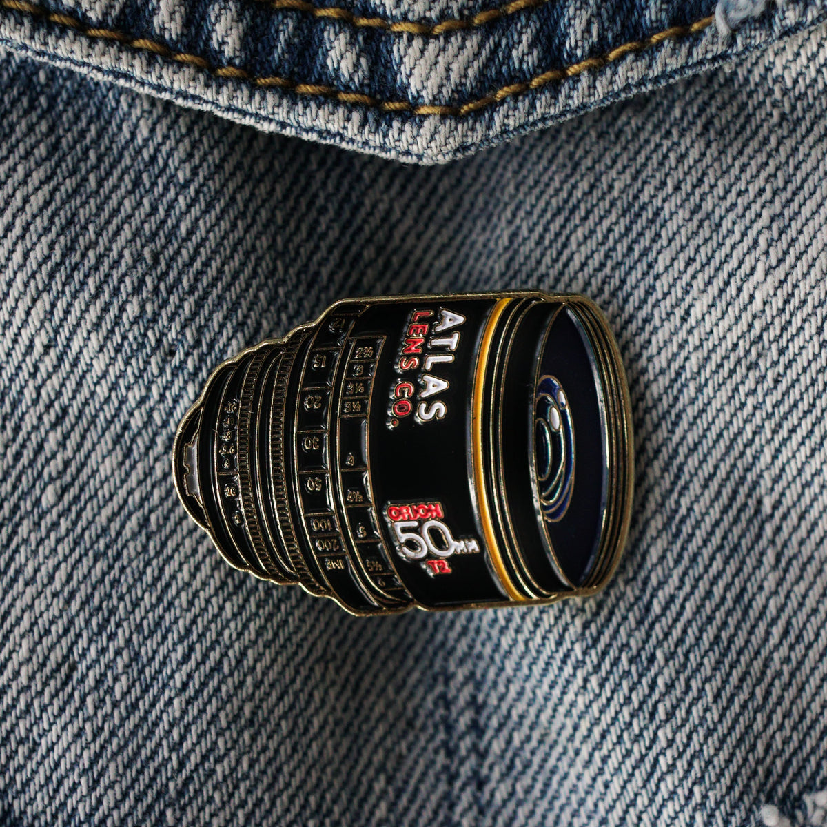 50mm Atlas Anamorphic Lens Enamel Pin on a jacket