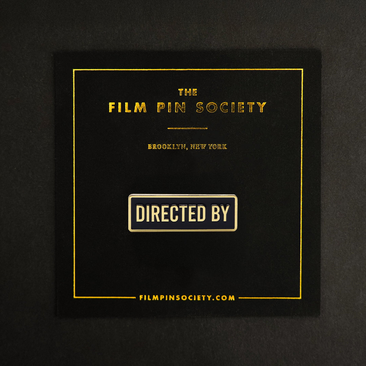 Directed By Credit Enamel Pin on backing card