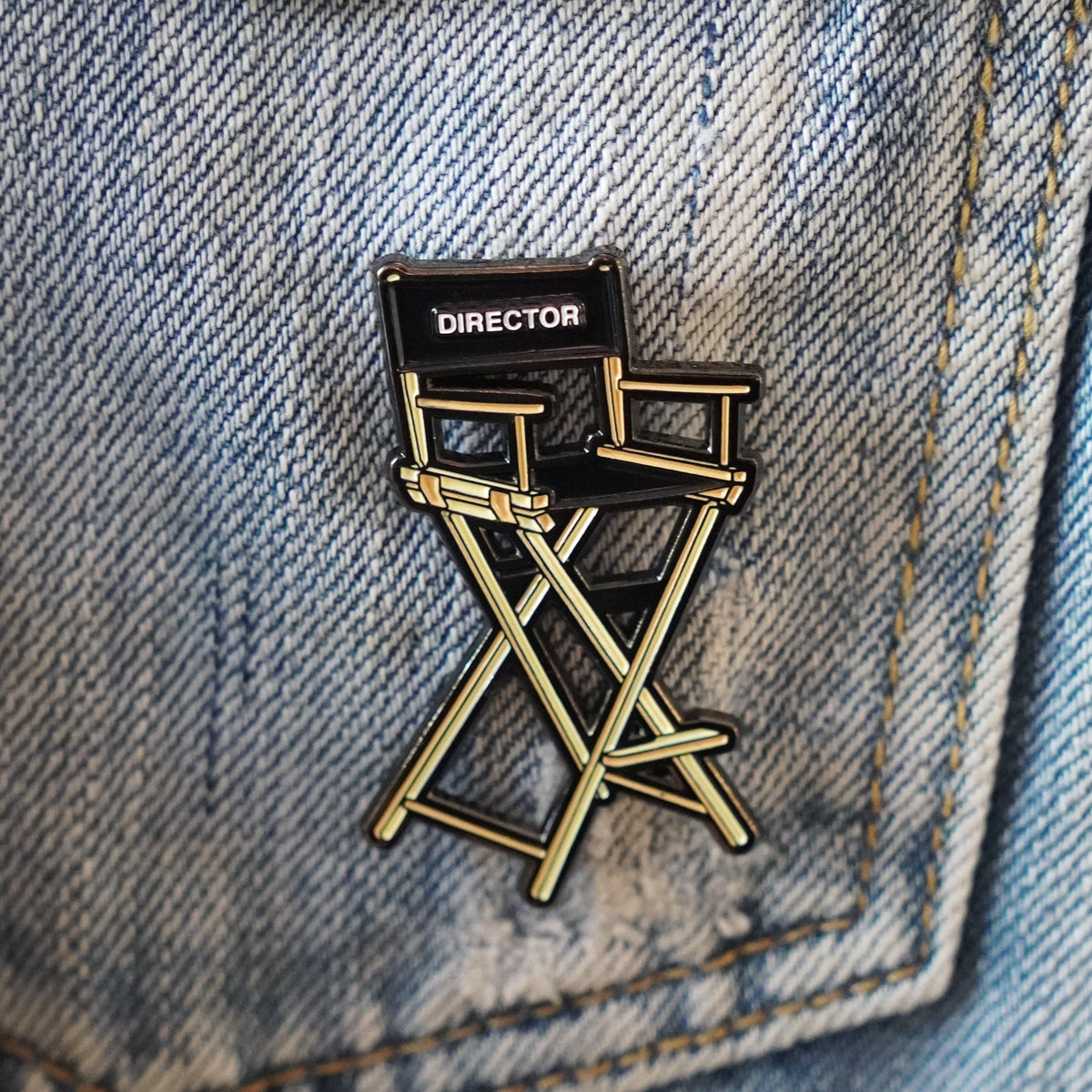 Director's Chair Enamel Pin on a jacket