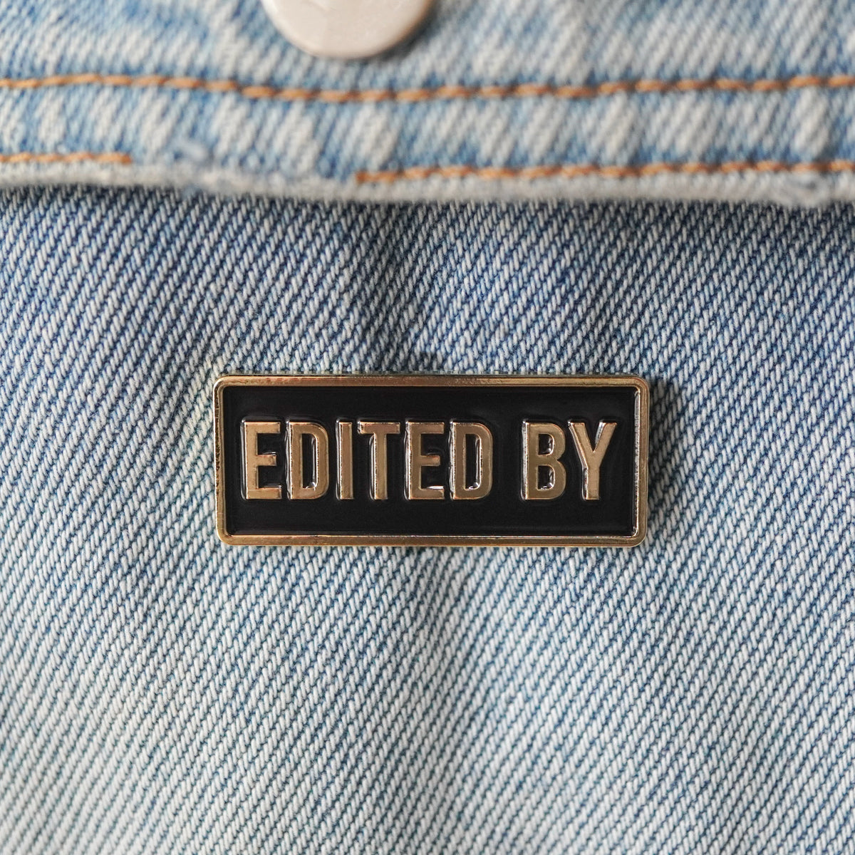 Edited By Credit Enamel Pin on a jacket