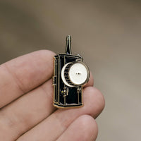 Follow Focus Enamel Pin in hand