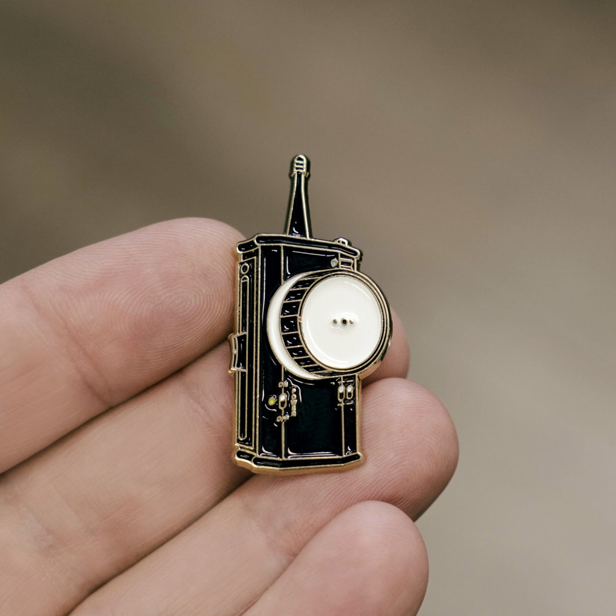 Follow Focus Enamel Pin in hand