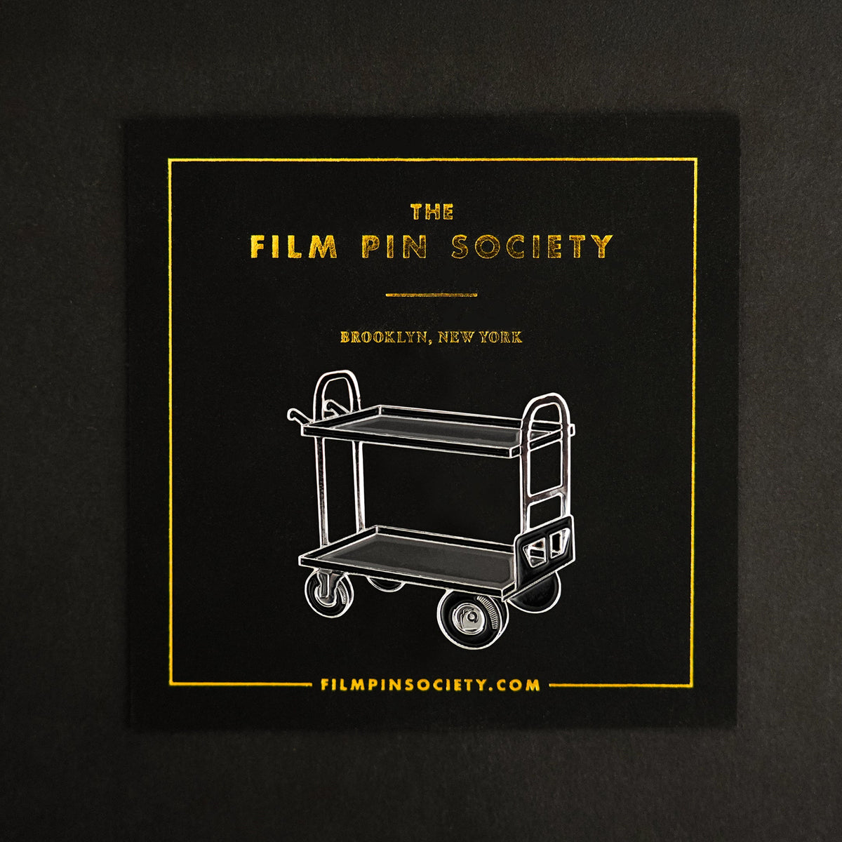 Film Cart Enamel Pin on backing card