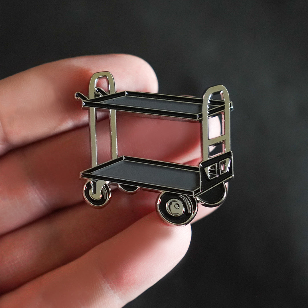 Film Cart Enamel Pin in hand