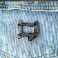 Film Cart Enamel Pin on a jacket