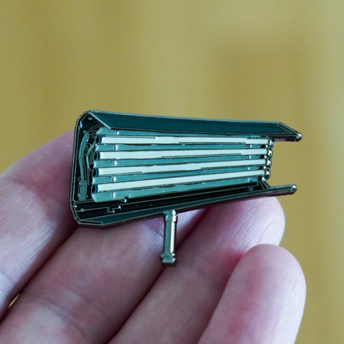 Fluorescent Light Enamel Pin in hand