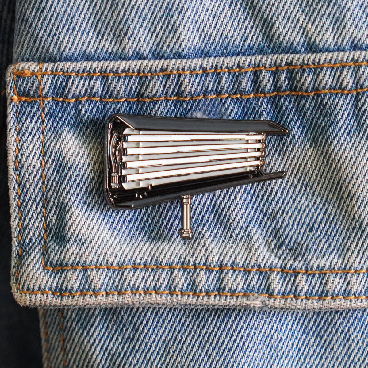 Fluorescent Light Enamel Pin on a jacket