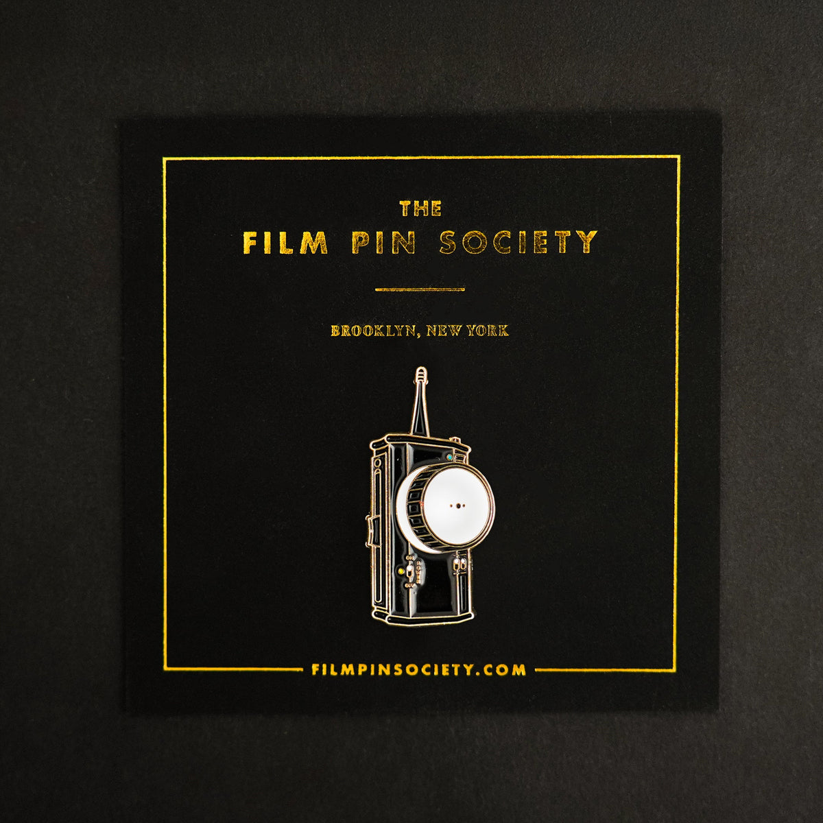 Follow Focus Enamel Pin on backing card