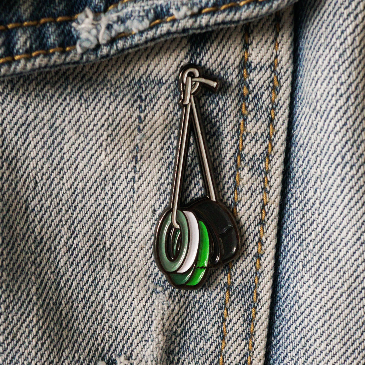 Gaff Tape Roll Enamel Pin on a jacket