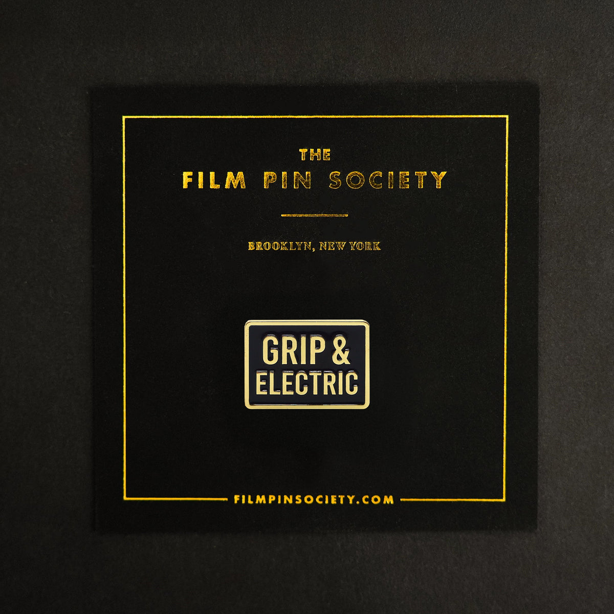 Grip & Electric Department Enamel Pin on backing card