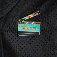 Jumbo Timecode Slate Enamel Pin on a bag