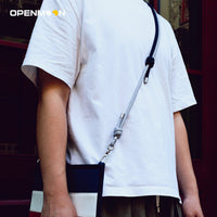 Woven crossbody strap shown with its clip