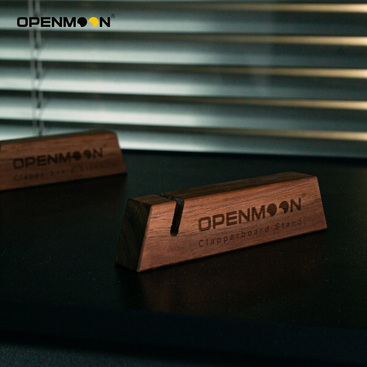 Pair of OpenMoon clapperboard stands holding a slate upright
