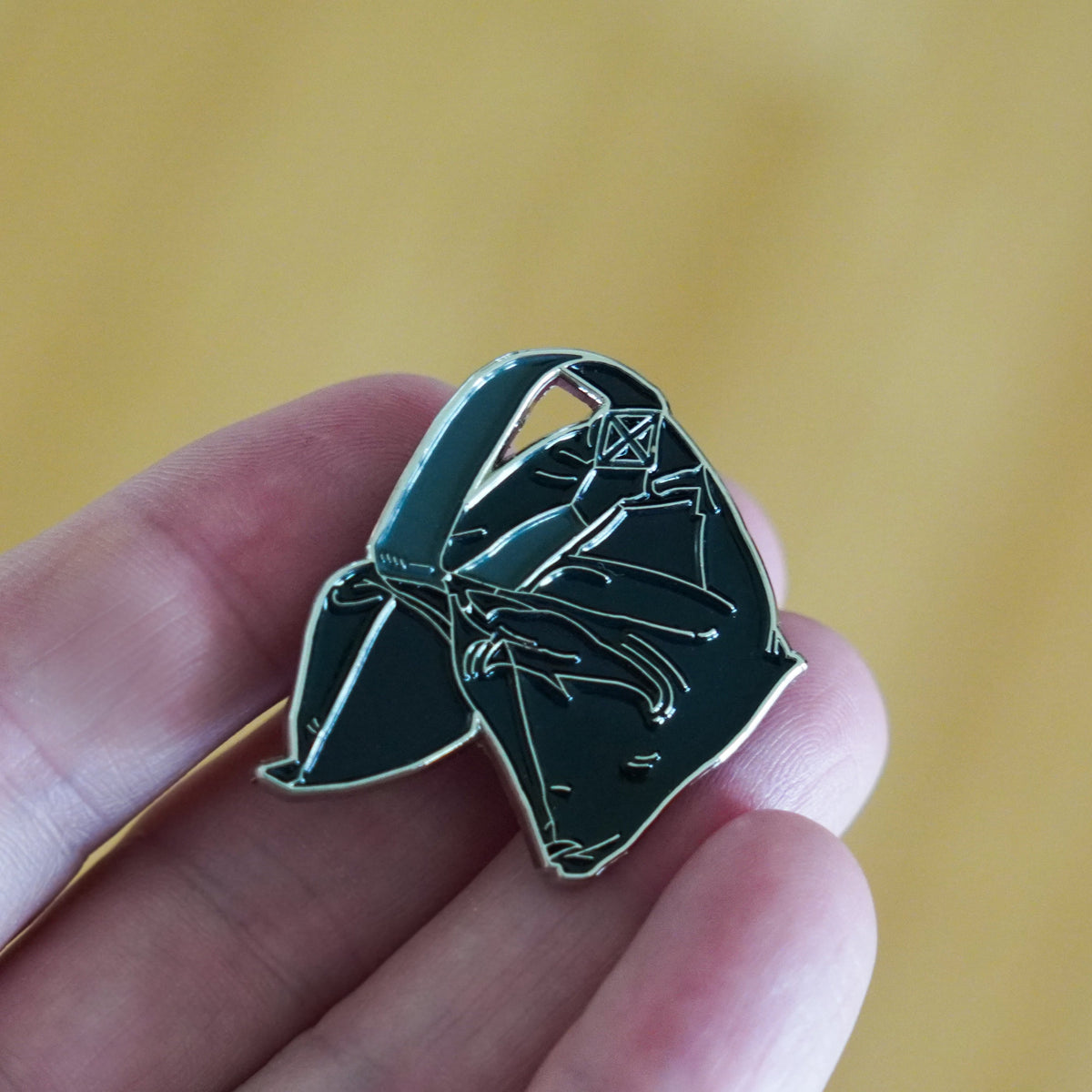 Sandbag Enamel Pin in hand