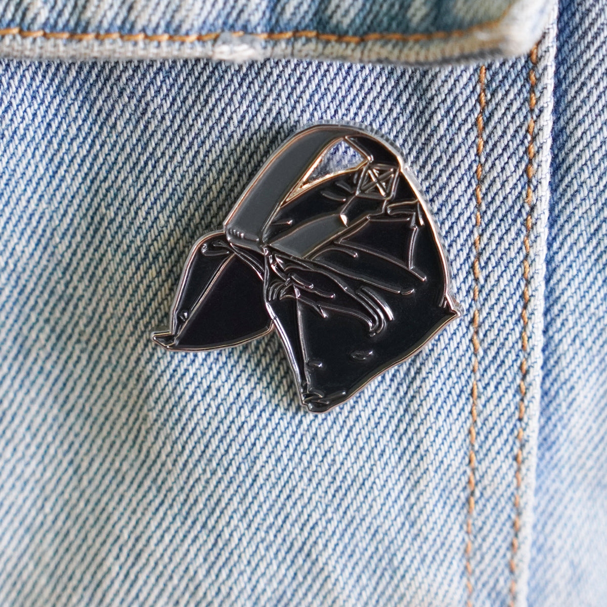 Sandbag Enamel Pin on a jacket