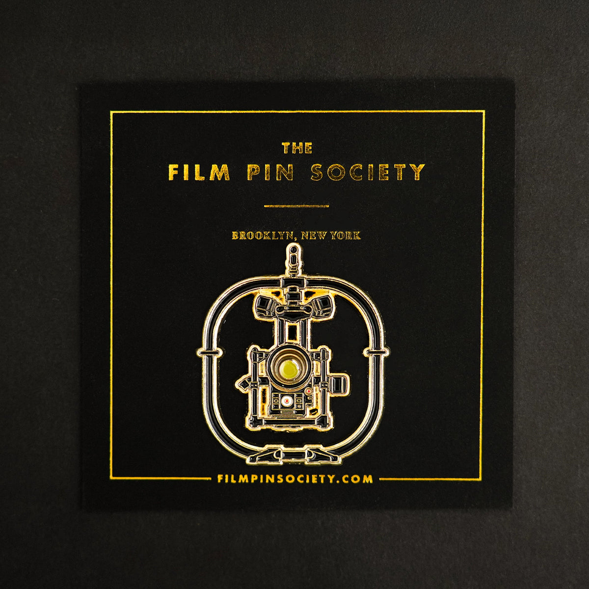 Camera Stabilizer Enamel Pin on backing card