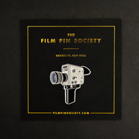Super 8 Camera Enamel Pin on backing card