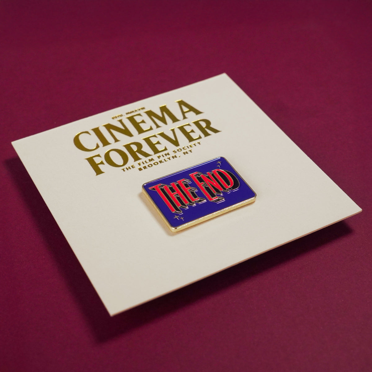 The End Credit Enamel Pin on backing card