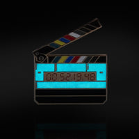Timecode Slate Enamel Pin glowing in the dark