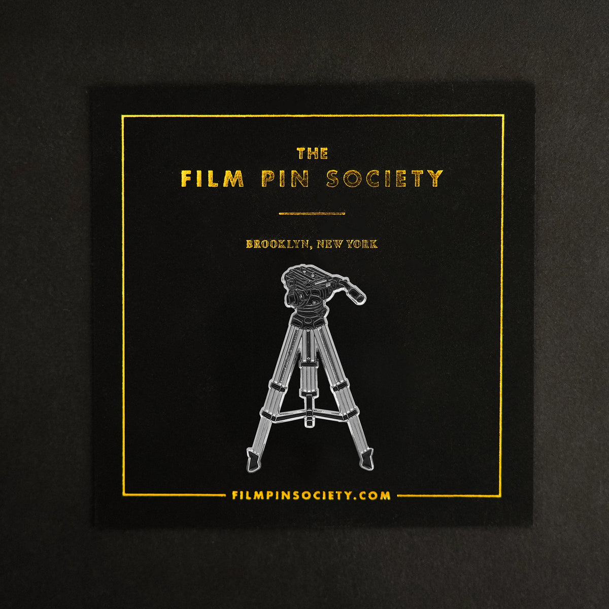 Tripod Enamel Pin on backing card