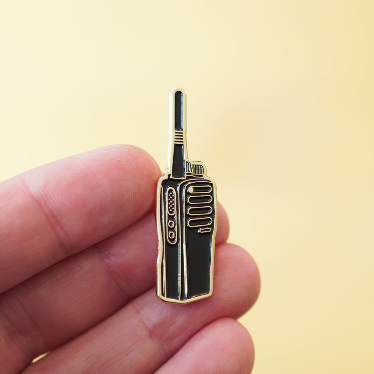 Walkie Talkie Enamel Pin in hand