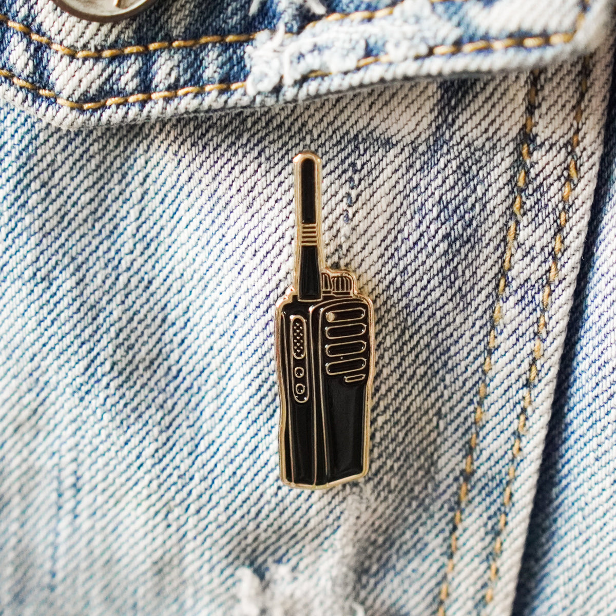 Walkie Talkie Enamel Pin on a jacket