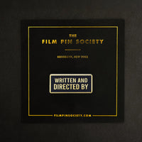 Written and Directed By Credit Enamel Pin on backing card