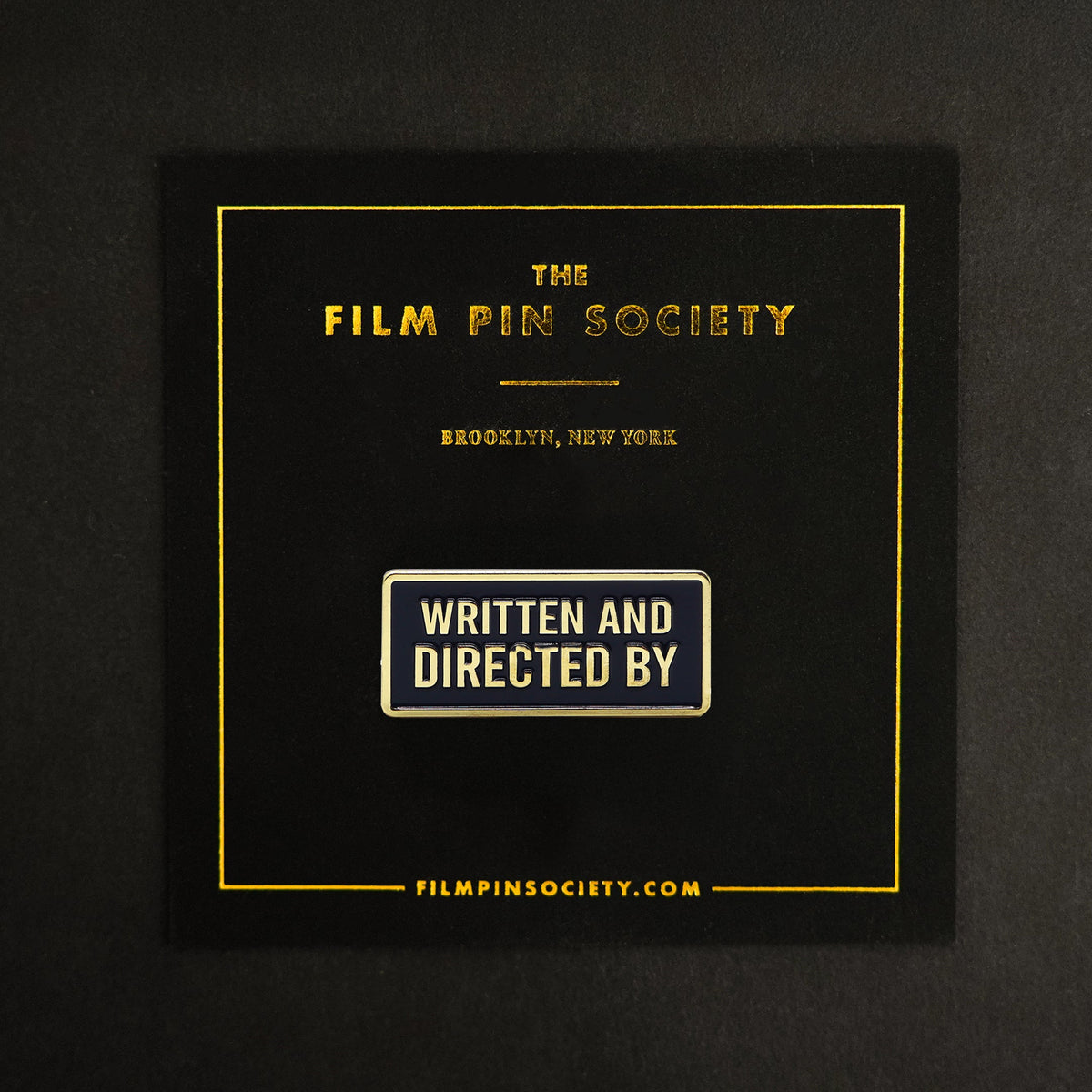 Written and Directed By Credit Enamel Pin on backing card