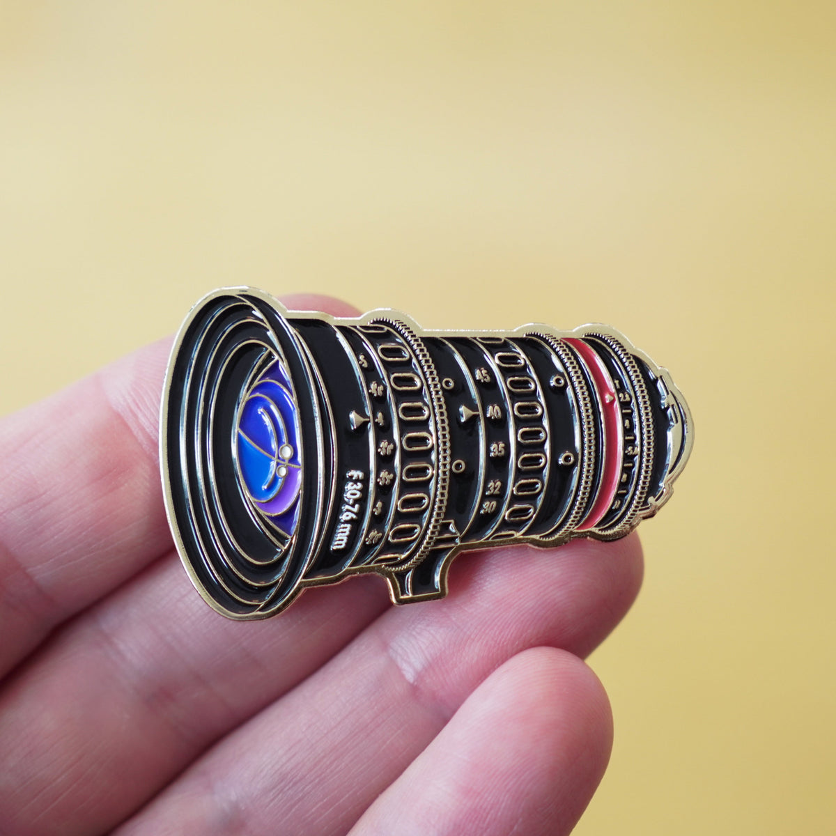 Cine Zoom Lens Enamel Pin in hand